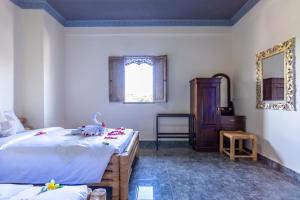 Postel nebo postele na pokoji v ubytování Kacu Ubud Inn