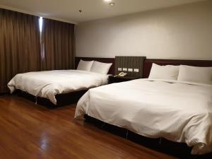 Postel nebo postele na pokoji v ubytování SunWang Hotel