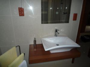 a bathroom with a sink and a mirror at Apartman K 306 in Veľká Lomnica