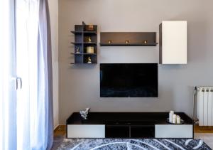 a living room with a black and white tv at Andria City Apartment in Zakynthos