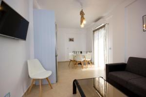 a living room with a couch and a table at Sahas Apartments in Mikonos