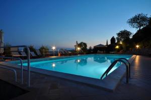 a swimming pool with a pool table in the middle of it at Agriturismo Montemari in Palaia