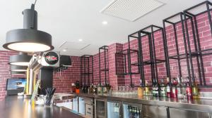 a bar in a restaurant with red brick walls at Hotel Paradiso Garden in Playa de Palma