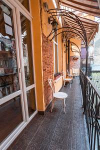 a balcony of a building with chairs and windows at GHOSTel - Medieval Hostel in Lviv