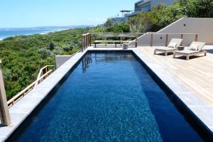an infinity pool with blue water in a house at Beachscape in Keurboomstrand
