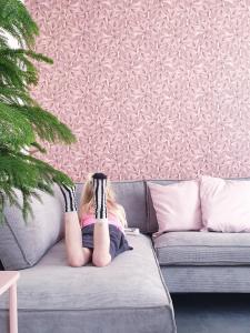 a little girl laying on a couch with her feet up at Appartement Plek in Holten in Holten