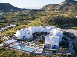 an aerial view of a white villa with a pool at Milos Breeze Boutique Hotel in Pollonia