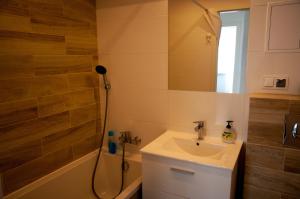 a bathroom with a sink and a shower at Apartament Wiesio in Gdynia