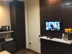 a room with a tv on a wall at Mirasol Residences in Daet