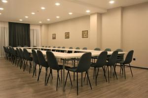 a conference room with a long table and chairs at Solomon in Kutaisi