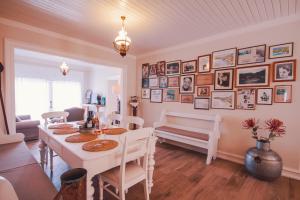 a dining room with a table and a bench at The Durrell White House in Kalami