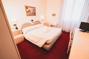 Letto o letti in una camera di Grand Hotel Milano