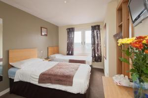 a bedroom with a bed and a window at Boreland Lodge Hotel in Inverkeithing