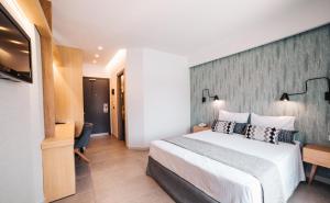 Postel nebo postele na pokoji v ubytování Minoa Hotel