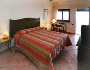 Un pat sau paturi într-o cameră la Il Poggio Dei Pettirossi