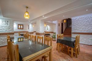 a dining room with a table and chairs at Hotel Dar Mounir in Chefchaouen