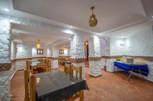 a dining room with a table and some chairs at Hotel Dar Mounir in Chefchaouen