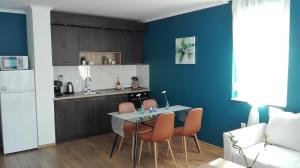 a kitchen with a table and chairs in a room at Azur Apartment Deluxe in Chernomorets