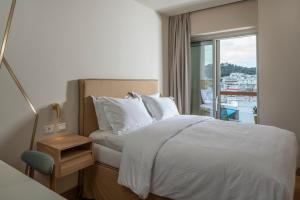 a hotel room with a bed and a window at Coco-mat Athens BC in Athens