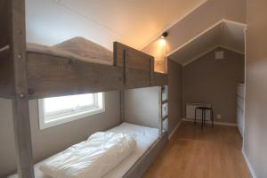 a bunk bed in a room with a window at Fjelltun 6-sengs in Trysil