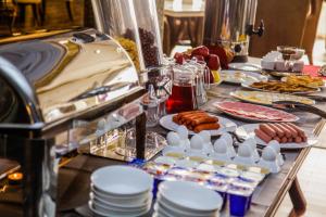 a buffet with plates of food on a table at Parliament Palace Hotel in Khujand
