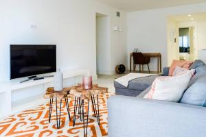 un soggiorno con divano e TV di Marina Puente Romano - Groundfloor - 3 Bedrooms a Marbella