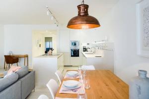 a living room and kitchen with a table and a couch at Marina Puente Romano - Groundfloor - 3 Bedrooms in Marbella