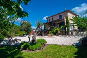 uma casa com uma árvore na frente em Les Bons Vivants Cévenols em Générargues