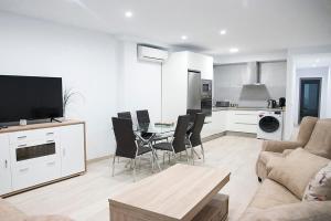 a living room with a couch and a table with chairs at Entre Patios La Victoria in Córdoba