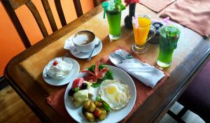 a table with a plate of breakfast food and drinks at Temple House in Kathmandu