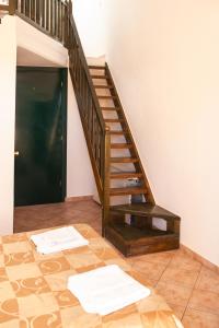 a staircase leading up to a room with a wooden floor at Villa Cariatis in Nea Kallikrateia