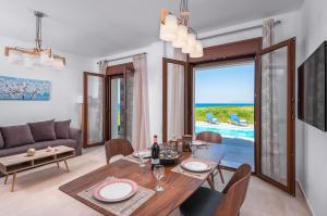 a living room with a dining table and a couch at Diagoras & Attalos Villas in Phanaes