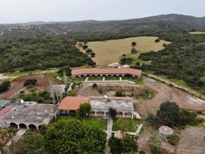 an aerial view of a large house with a field at Elausa Hotel & Restaurant in Rizokarpaso