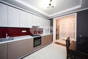 a kitchen with white cabinets and a stove top oven at Alba-Iulia Vip Residence in Chişinău