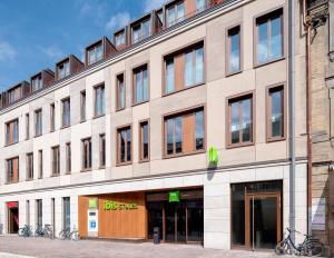 a building with a large window on the side of it at ibis Styles Bamberg in Bamberg