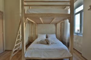 a bedroom with a bed and a window at Ederlezi Boutique Hotel in Athens