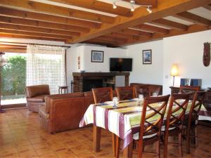 a living room with a table and a couch at Holiday Home Roitelet by Interhome in Mimizan-Plage