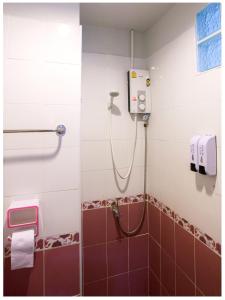 a shower in a bathroom with red tiles at Namhasin House in Ko Tao +68 photos