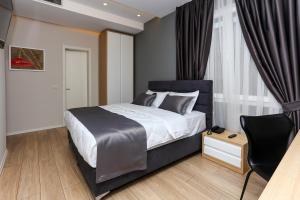 Postel nebo postele na pokoji v ubytování Emerald Boutique Hotel