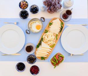 a table with plates and bowls of food at Ela Tenedos Hotel - Special Category in Bozcaada +22 photos
