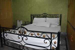 a black and white bed with white sheets and pillows at Paramid II in Islamabad