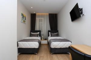 Postel nebo postele na pokoji v ubytování Emerald Boutique Hotel
