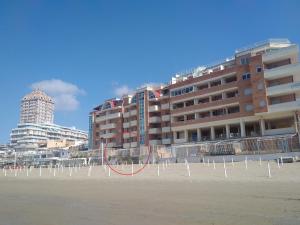 a large building on the beach with a red circle at Incantevole casa sul mare vicino a Roma in Nettuno