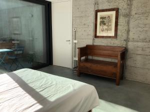 a bedroom with a bed and a dresser and a table at Da La Babi B&B in Arco