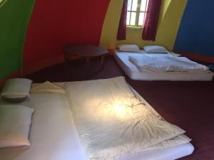 a room with two beds and a table at Hotel At The End Of The Universe in Nagarkot