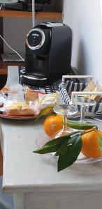 una mesa con naranjas y una impresora en Un Tetto Di Stelle Deluxe Home, en Salerno