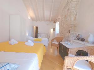 a room with two beds and a table and chairs at Historic Piazza House & Romantic Hidden Garden in Hvar