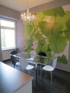 a dining room with a glass table and chairs at Berlinapartments-Downtown in Berlin +28 photos