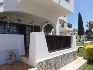 a white house with a balcony and a yard at Siesta mar 2 in Cala'n Porter