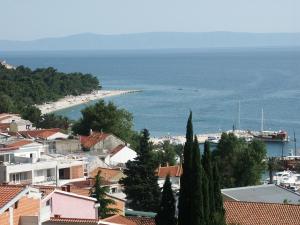 a view of a town with a beach and the ocean at Apartments Šarić in Baška Voda